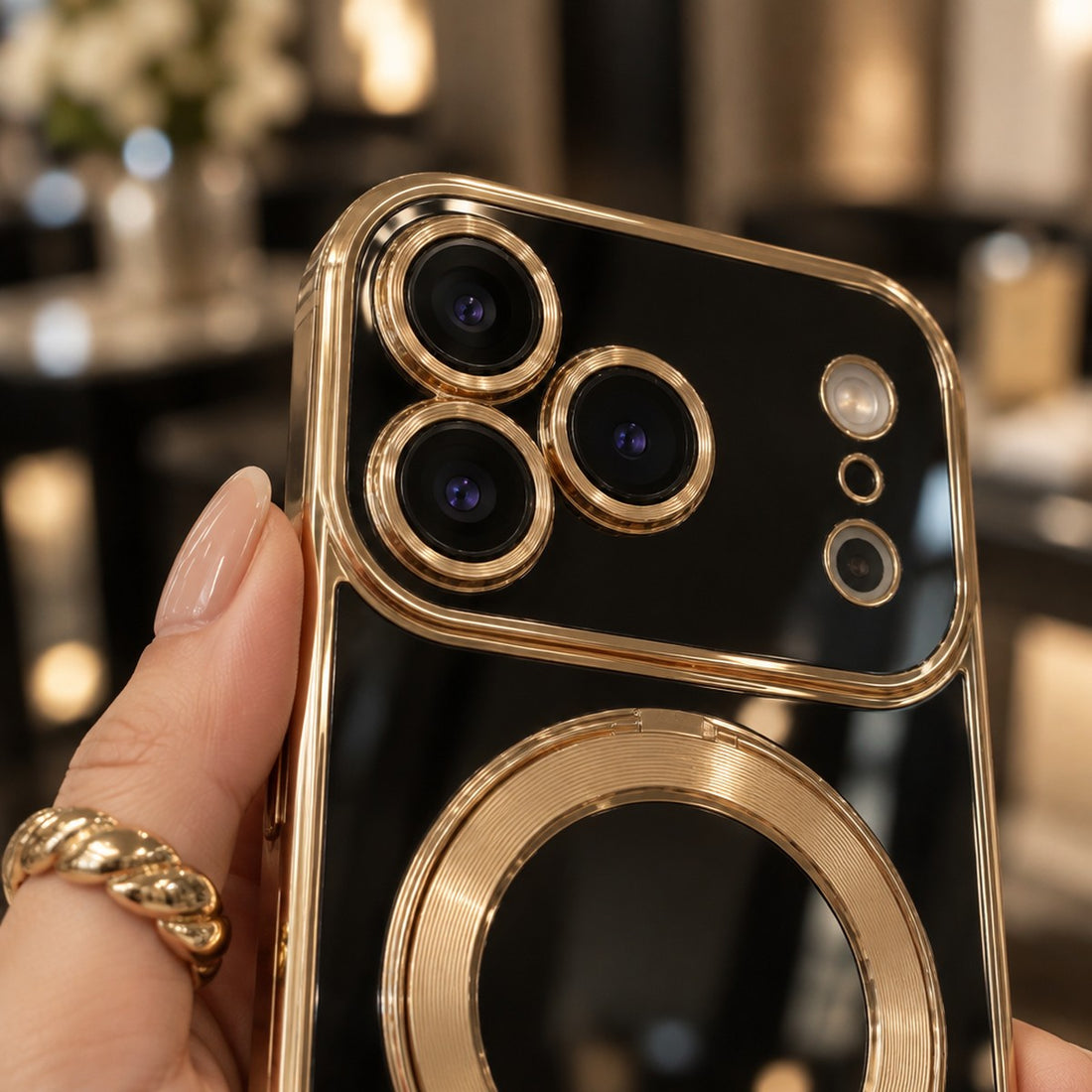 Close-up of the raised gold camera guard on a black Infinity case